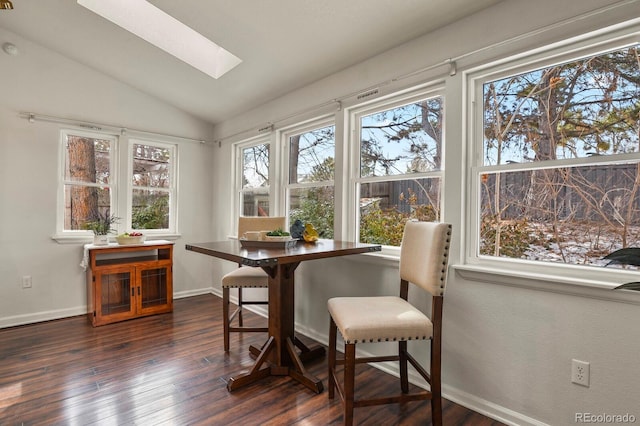 sunroom featuring vaulted ceiling with skylight and breakfast area