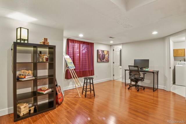 office featuring hardwood / wood-style flooring and washer / dryer