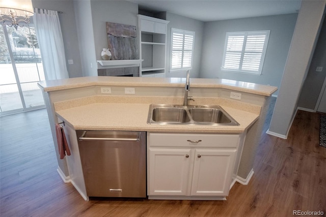 kitchen featuring a sink, white cabinetry, dishwasher, and an island with sink