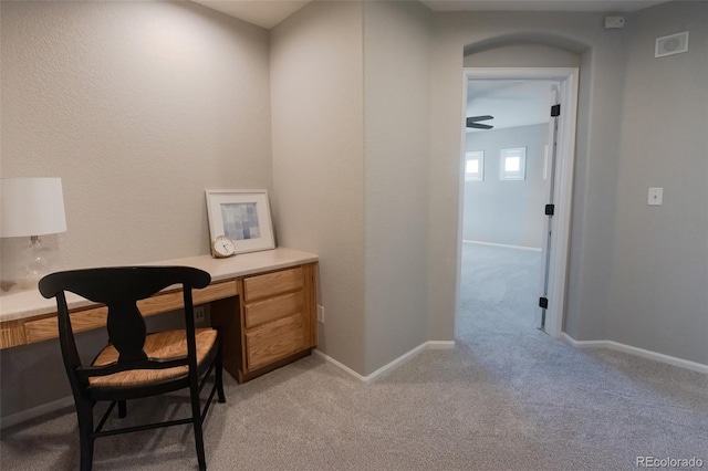 office space with light colored carpet, visible vents, and baseboards