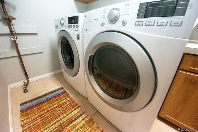 laundry room featuring cabinet space, light tile patterned floors, baseboards, mail area, and washing machine and dryer