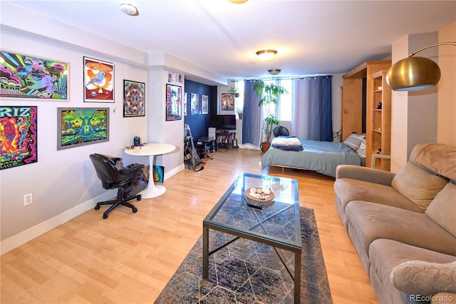 bedroom featuring baseboards and wood finished floors