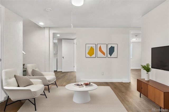 sitting room with light wood finished floors and baseboards