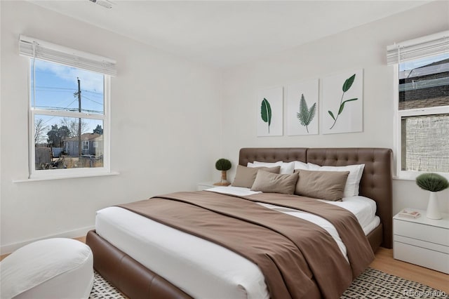 bedroom with light wood-type flooring and visible vents