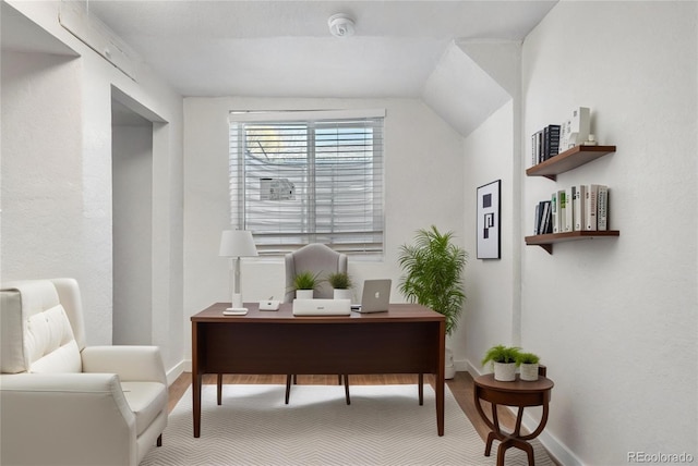 office featuring lofted ceiling and baseboards