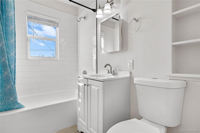 full bath with a textured wall, shower / bath combo, vanity, and toilet