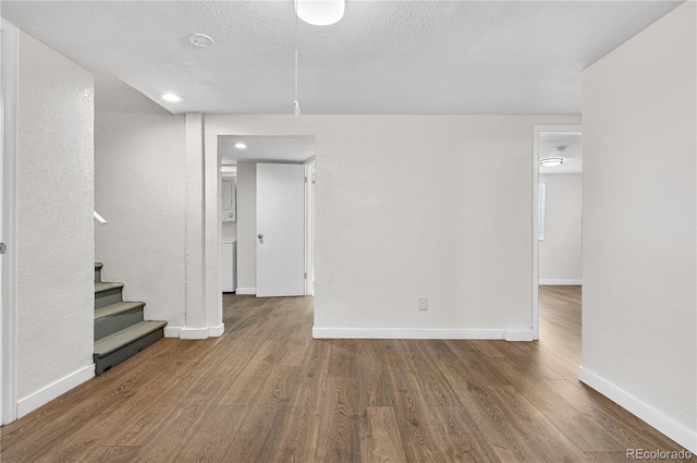 spare room featuring wood finished floors and baseboards