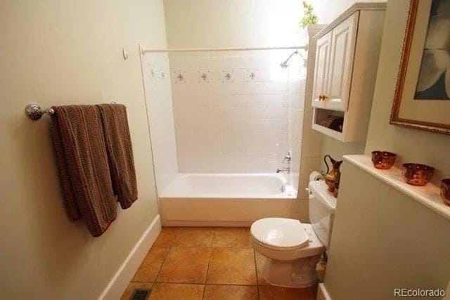 full bathroom featuring tile patterned floors, visible vents, toilet, and tub / shower combination