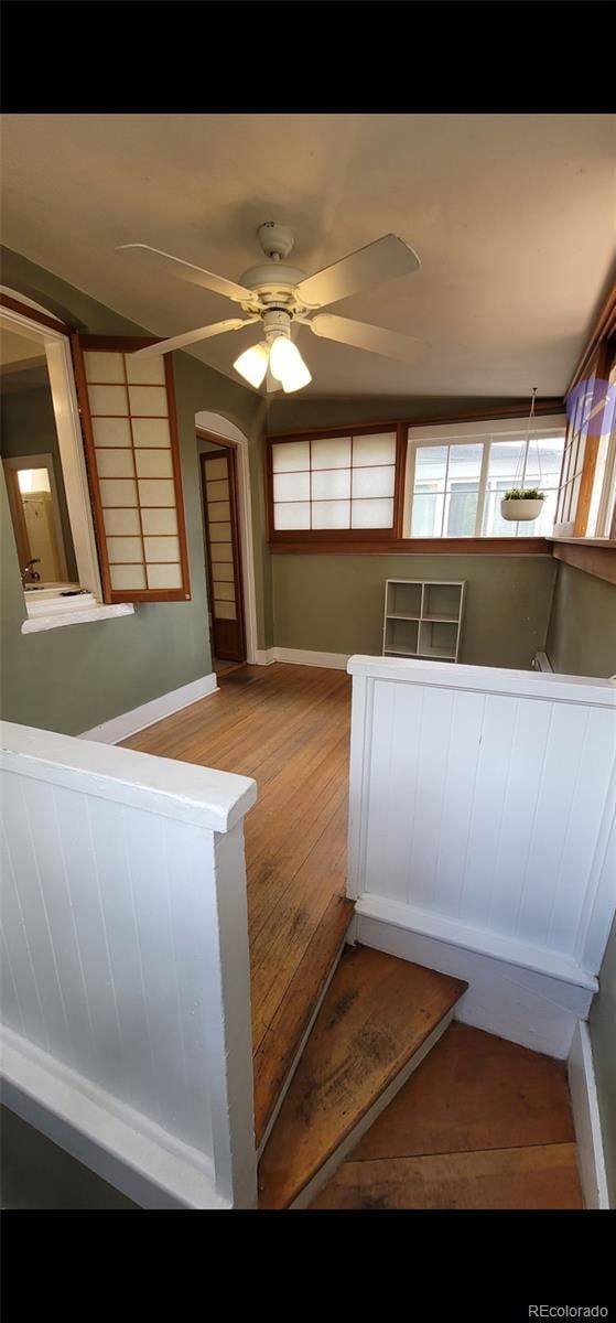 914 E Iowa Ave, Denver, CO 80210 - staircase with wood finished floors, ceiling fan, and baseboards