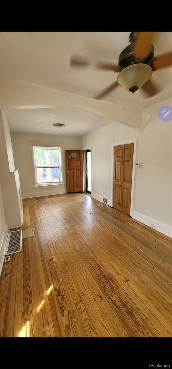 914 E Iowa Ave, Denver, CO 80210 - unfurnished living room with baseboards, ceiling fan, and hardwood / wood-style floors
