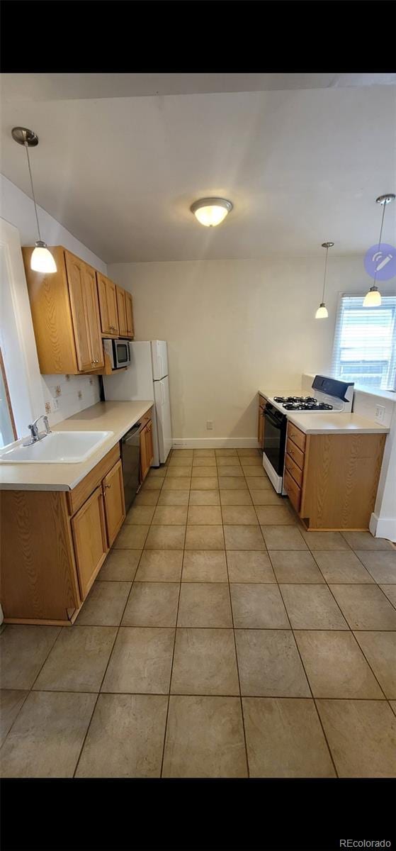 914 E Iowa Ave, Denver, CO 80210 - kitchen with range with gas cooktop, a sink, dishwasher, stainless steel microwave, and light tile patterned flooring