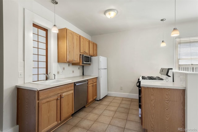 914 E Iowa Ave, Denver, CO 80210 - kitchen with stainless steel appliances, tasteful backsplash, light countertops, and hanging light fixtures