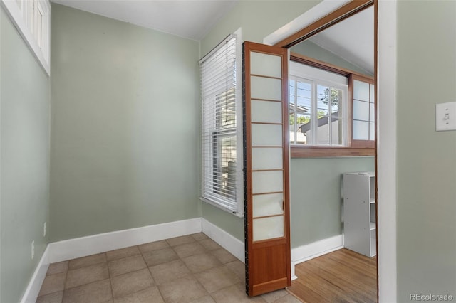 914 E Iowa Ave, Denver, CO 80210 - empty room with baseboards and lofted ceiling