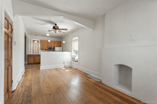 914 E Iowa Ave, Denver, CO 80210 - unfurnished living room with light wood-type flooring and a ceiling fan