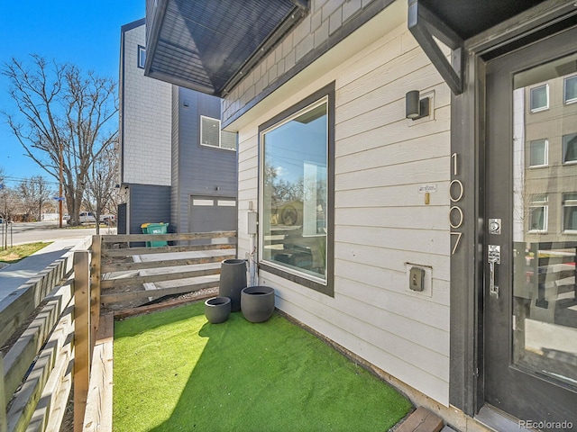 doorway to property featuring fence