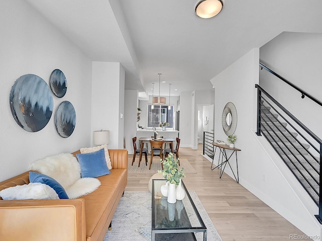 living area with baseboards and light wood-style flooring