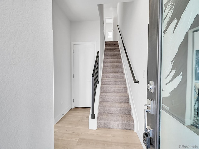 staircase featuring wood finished floors