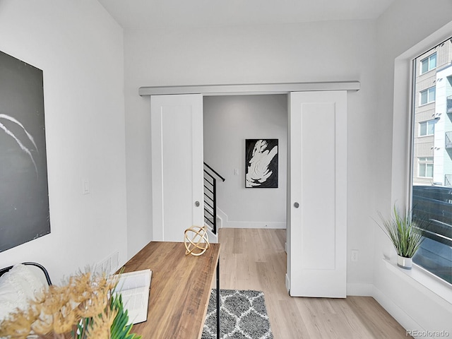 interior space with baseboards and wood finished floors