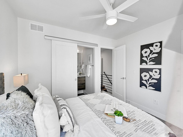 bedroom featuring visible vents, baseboards, ensuite bath, and ceiling fan