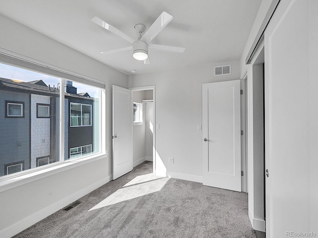 unfurnished bedroom featuring baseboards, visible vents, and carpet floors