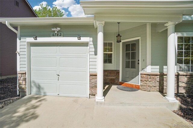 6142 Gorham St, Frederick, CO 80530 - garage featuring a porch and concrete driveway