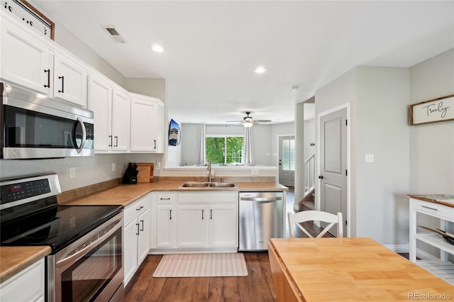 6142 Gorham St, Frederick, CO 80530 - kitchen with appliances with stainless steel finishes, a sink, dark wood-type flooring, white cabinets, and a ceiling fan