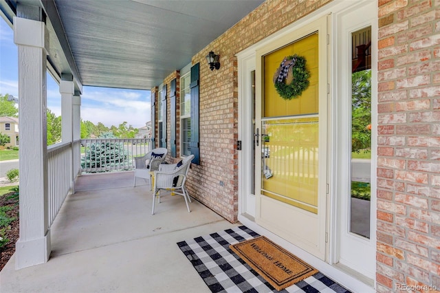 9954 Heywood St, Highlands Ranch, CO 80130 - view of exterior entry featuring covered porch and brick siding