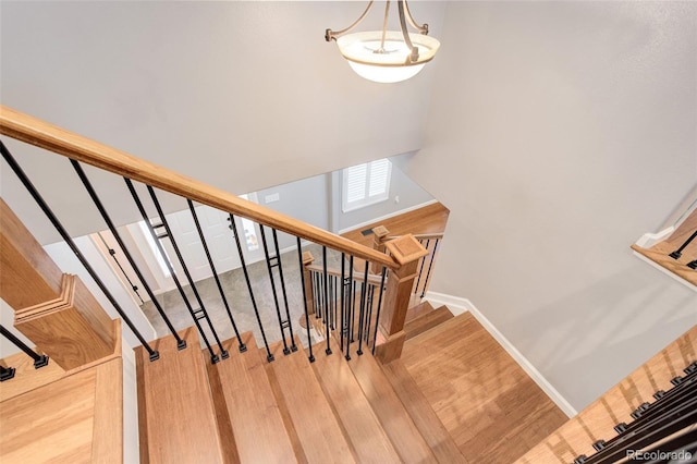 9954 Heywood St, Highlands Ranch, CO 80130 - staircase featuring wood finished floors and baseboards