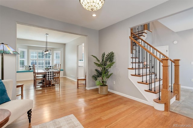9954 Heywood St, Highlands Ranch, CO 80130 - living area with light wood-style floors, stairway, baseboards, and recessed lighting