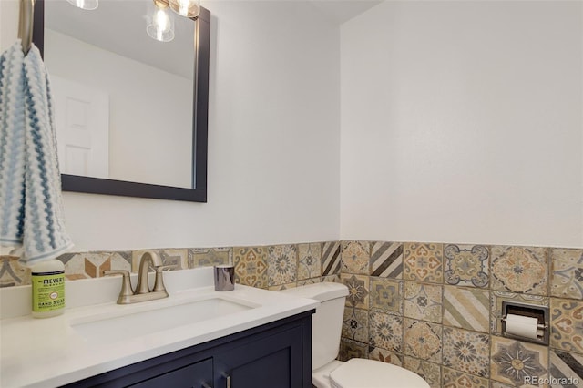 9954 Heywood St, Highlands Ranch, CO 80130 - half bath featuring tile walls, toilet, vanity, and wainscoting