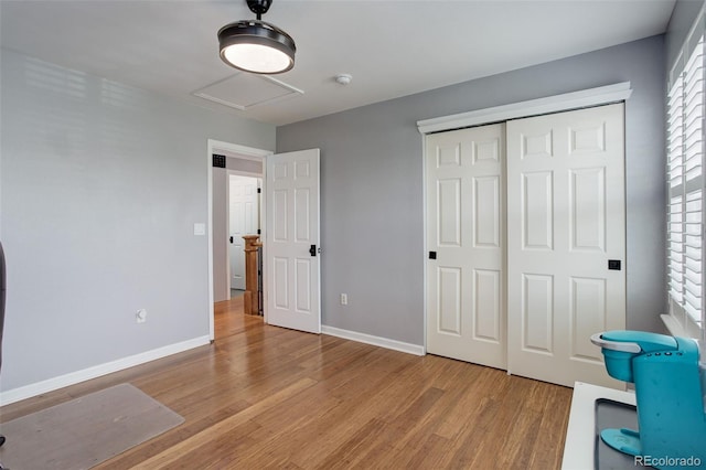 9954 Heywood St, Highlands Ranch, CO 80130 - unfurnished bedroom featuring wood finished floors, baseboards, attic access, and a closet