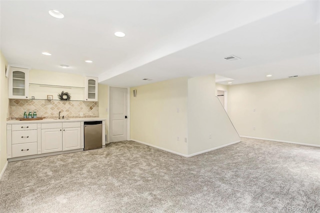 9954 Heywood St, Highlands Ranch, CO 80130 - indoor wet bar featuring light colored carpet, decorative backsplash, baseboards, stainless steel dishwasher, and recessed lighting