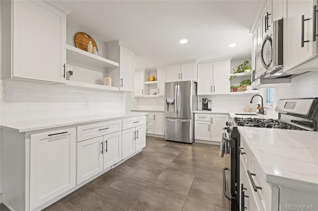 13402 W 24th Pl, Golden, CO 80401 - kitchen featuring open shelves, appliances with stainless steel finishes, a sink, tasteful backsplash, and white cabinets