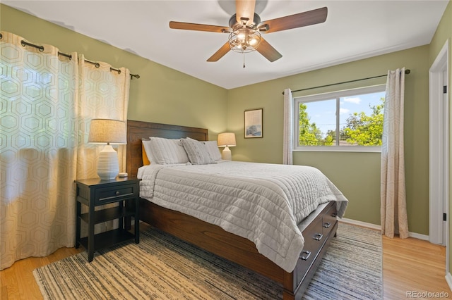 13402 W 24th Pl, Golden, CO 80401 - bedroom with light wood finished floors, ceiling fan, and baseboards