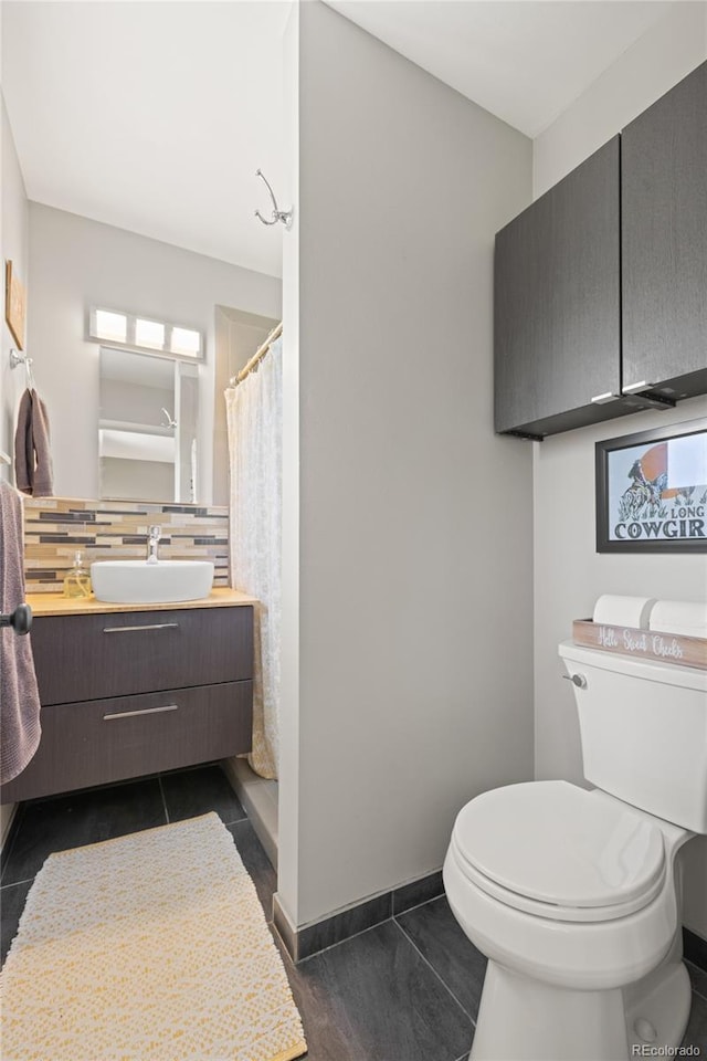 13402 W 24th Pl, Golden, CO 80401 - full bathroom with tasteful backsplash, toilet, vanity, curtained shower, and baseboards