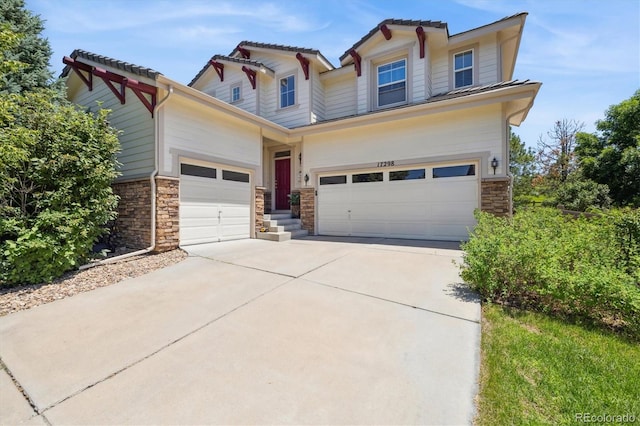17298 E Lake Pl, Aurora, CO 80016 - craftsman-style home featuring stone siding, concrete driveway, and an attached garage