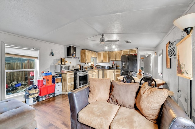 8430 Madison Way, Denver, CO 80229 - living area with wood finished floors, ceiling fan, lofted ceiling, and a textured ceiling
