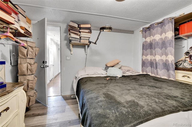 8430 Madison Way, Denver, CO 80229 - bedroom with wood finished floors and a textured ceiling
