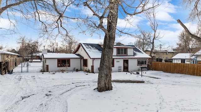 view of snow covered rear of property