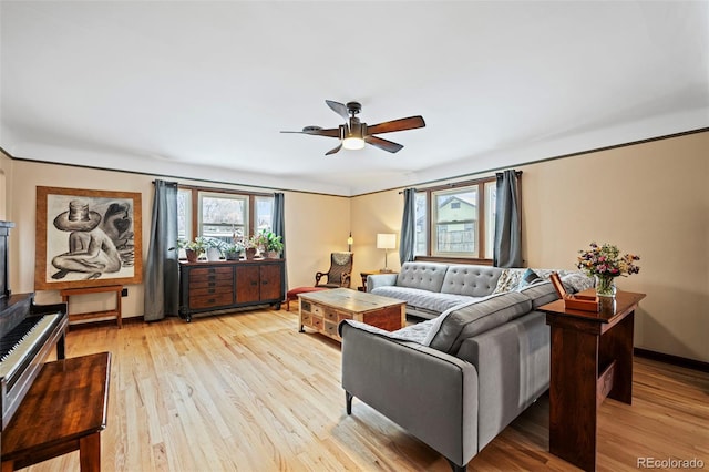 living room featuring light hardwood / wood-style flooring and ceiling fan