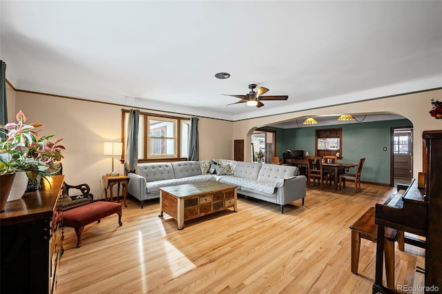 living room with ceiling fan and light hardwood / wood-style flooring