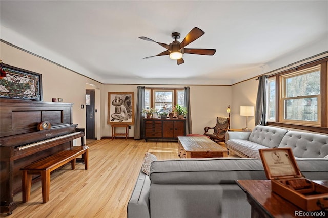 living room featuring light wood-type flooring and ceiling fan