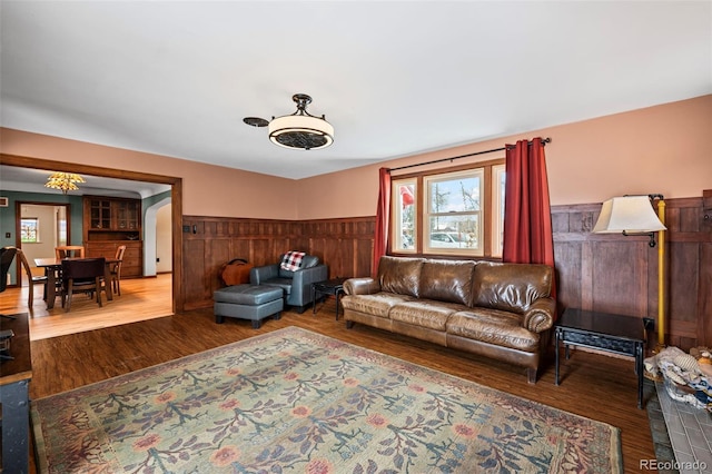 living room with wood-type flooring and wooden walls