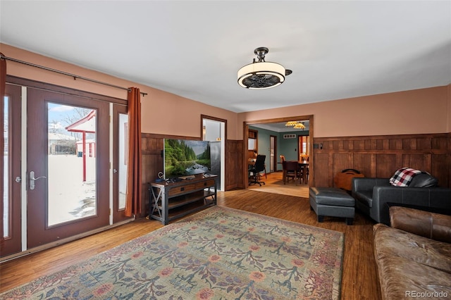 living room with wood-type flooring and wood walls