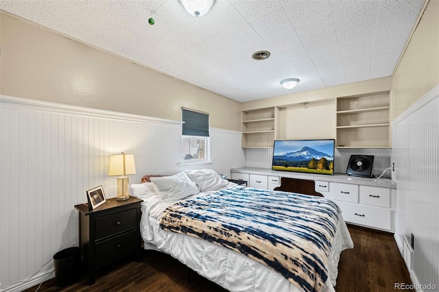 bedroom with dark hardwood / wood-style flooring