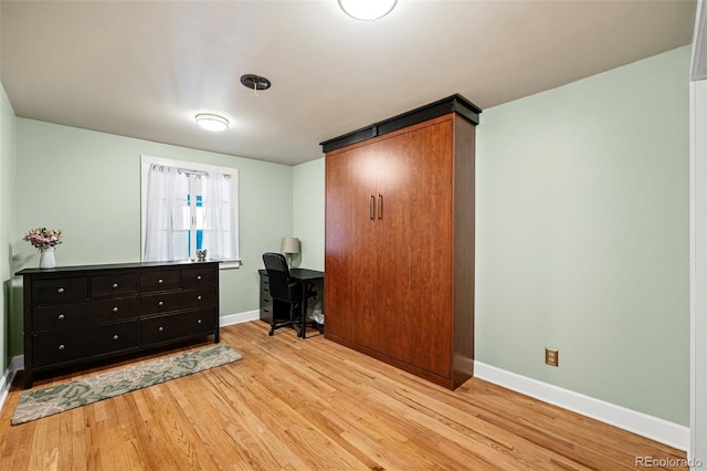 office with light wood-type flooring