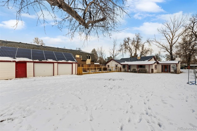 snowy yard with a garage