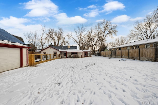 yard covered in snow featuring a garage