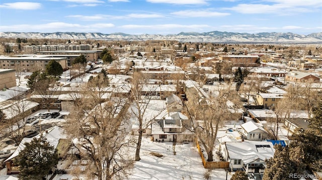 snowy aerial view with a mountain view