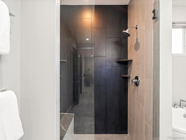 bathroom with a tile shower